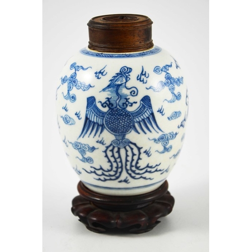 387 - A Chinese blue and white ginger jar, probably 18th century, painted with a fire bird and dragon in a... 