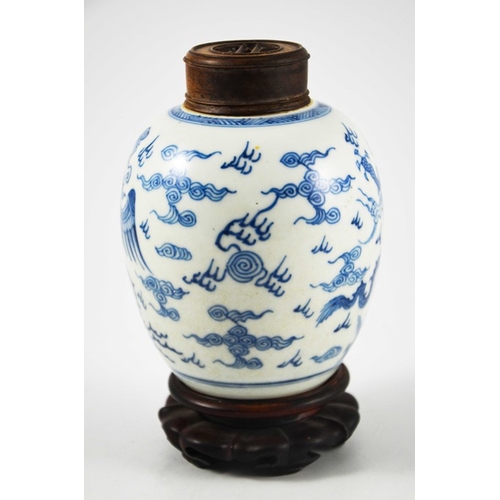 387 - A Chinese blue and white ginger jar, probably 18th century, painted with a fire bird and dragon in a... 