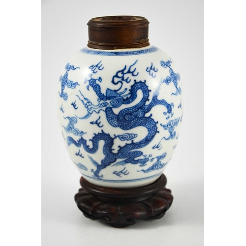 387 - A Chinese blue and white ginger jar, probably 18th century, painted with a fire bird and dragon in a... 