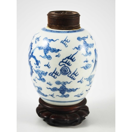 387 - A Chinese blue and white ginger jar, probably 18th century, painted with a fire bird and dragon in a... 