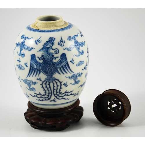 387 - A Chinese blue and white ginger jar, probably 18th century, painted with a fire bird and dragon in a... 