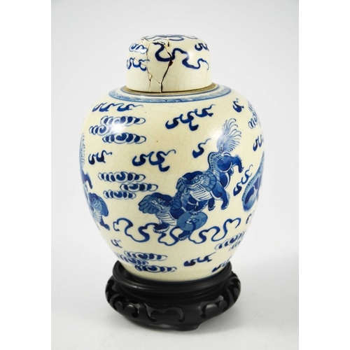 388 - A Chinese blue and white ginger jar and cover, Kangxi mark, painted with dogs in clouds, on a hardwo... 