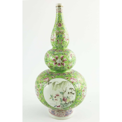 390 - A Chinese famille rose triple gourd vase, Qianlong style, early 19th century Qing, green ground with... 