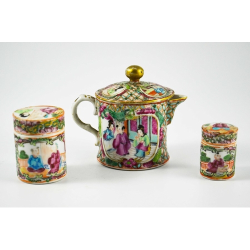 399 - A Chinese famille rose small teapot and two cylindrical jars, Cantonese, probably 19th century, deco... 