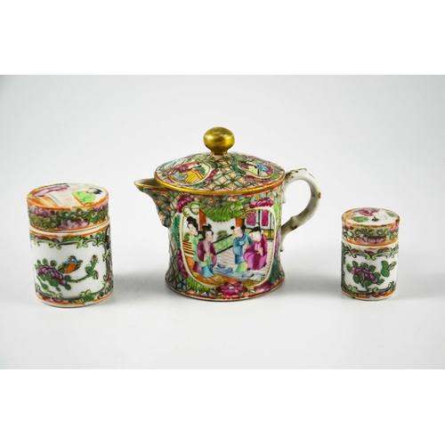 399 - A Chinese famille rose small teapot and two cylindrical jars, Cantonese, probably 19th century, deco... 