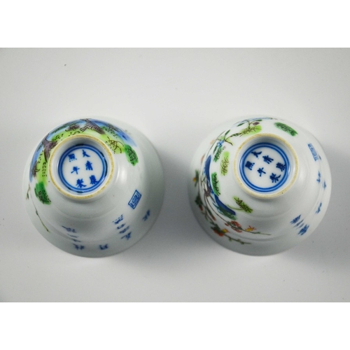 418 - A pair of Chinese Doucai cups or tea bowls, Kangxi marks, footed bell form, painted with prunus and ... 