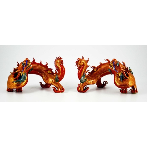 425 - A Pair of Chinese Porcelain Dragons decorated in gilt and coloured enamels on terracotta and gilt gr... 