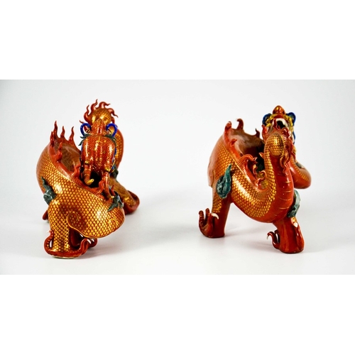 425 - A Pair of Chinese Porcelain Dragons decorated in gilt and coloured enamels on terracotta and gilt gr... 