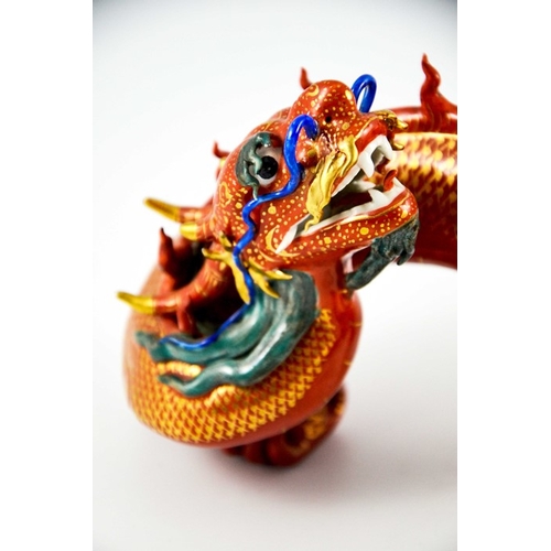 425 - A Pair of Chinese Porcelain Dragons decorated in gilt and coloured enamels on terracotta and gilt gr... 