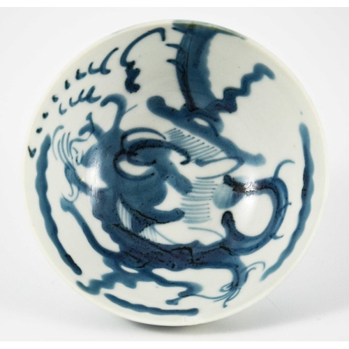 426 - An Oriental blue and white dragon bowl, painted to the interior and exterior with clouds and creatur... 