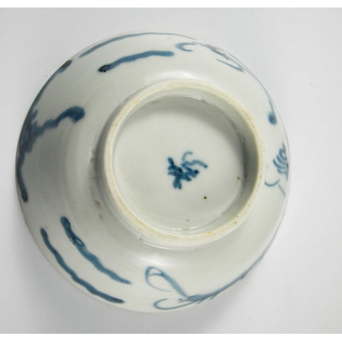 426 - An Oriental blue and white dragon bowl, painted to the interior and exterior with clouds and creatur... 