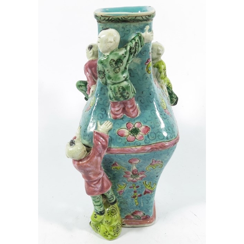 430b - An Oriental vase, square section lozenge form relief moulded with acrobatic boys, 22cm high