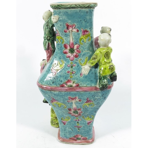 430b - An Oriental vase, square section lozenge form relief moulded with acrobatic boys, 22cm high