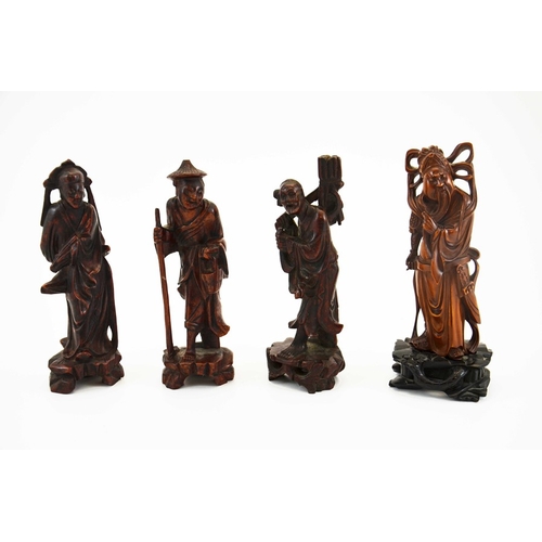 441 - Four Chinese carved hardwood figures, modelled as deities and old men, 21.5cm high (4)