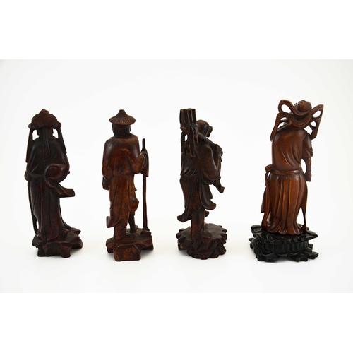 441 - Four Chinese carved hardwood figures, modelled as deities and old men, 21.5cm high (4)