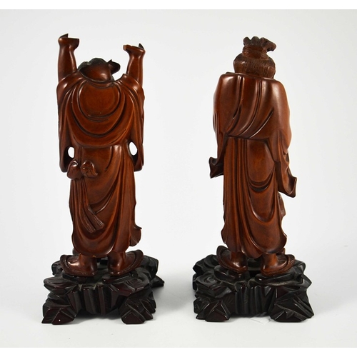 442 - A pair of Chinese carved hardwood figures, 19th century, modelled as old men with teapots, one takin... 