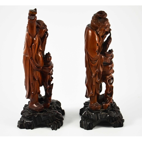 442 - A pair of Chinese carved hardwood figures, 19th century, modelled as old men with teapots, one takin... 