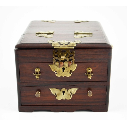 443 - A Chinese hardwood toilet chest, fitted with white metal mounts, two drawers and a double hinged lid... 