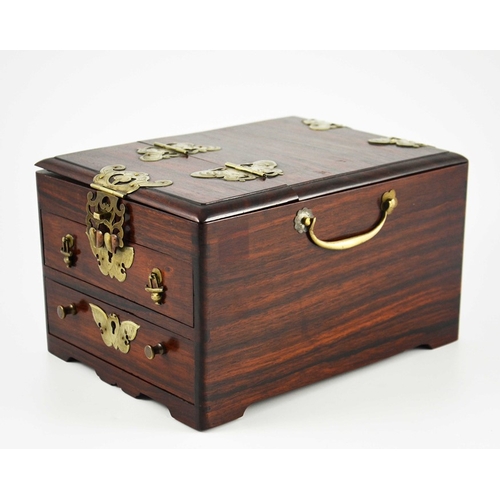 443 - A Chinese hardwood toilet chest, fitted with white metal mounts, two drawers and a double hinged lid... 