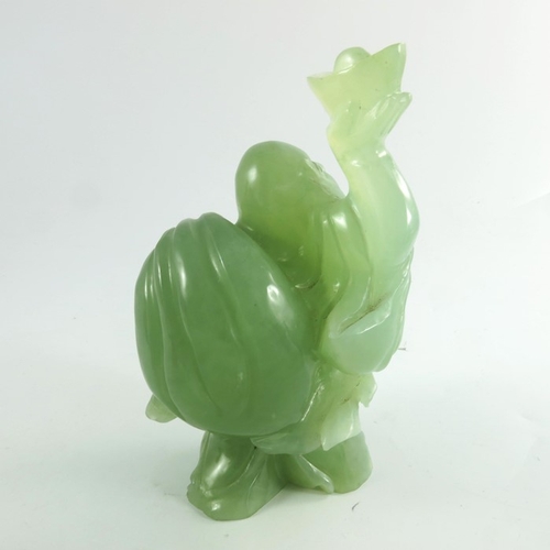 449 - A Chinese green stone carving of a deity, 20cm high