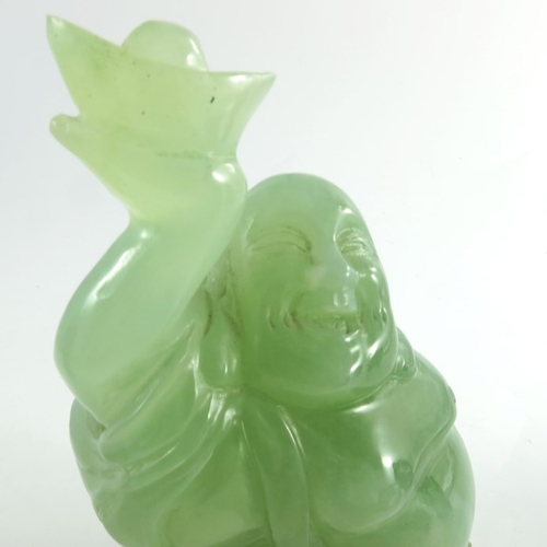 449 - A Chinese green stone carving of a deity, 20cm high