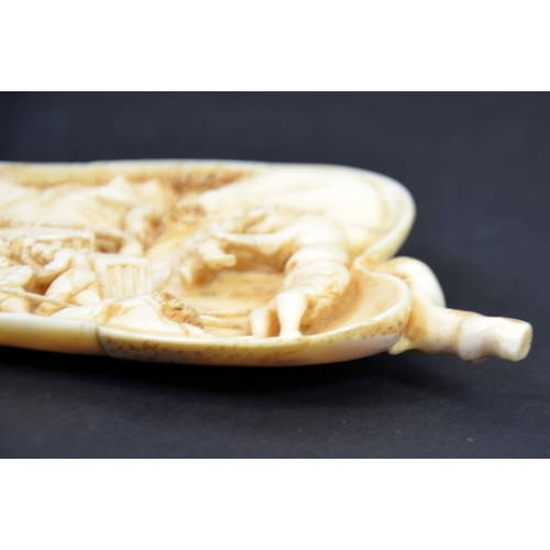 451 - λ A 19th century carved ivory finger citron, the interior modelled in relief with a quarry scene and... 