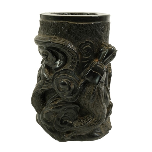 452 - A large Chinese lignite or black lacquer resin brush pot, carved with a wrythen dragon to one side, ... 