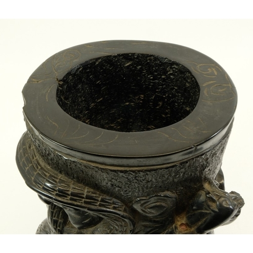 452 - A large Chinese lignite or black lacquer resin brush pot, carved with a wrythen dragon to one side, ... 