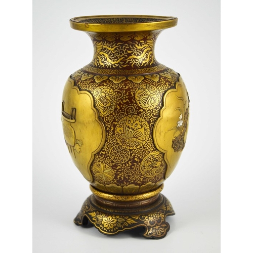 456 - A Japanese Shibayama gold lacquered vase, Meiji, shouldered form on integrated ogee bracket base, de... 