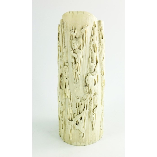 458 - A 19th century Chinese carved ivory tusk jug, modelled in relief with grotesque figures in a texture... 