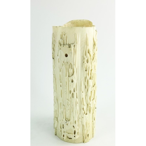 458 - A 19th century Chinese carved ivory tusk jug, modelled in relief with grotesque figures in a texture... 