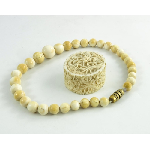 463 - A 19th century Chinese carved ivory box and a graduated bead necklace, the box modelled in relief as... 