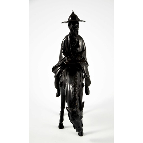 483 - An Oriental bronze figure of a man on a horse, probably 19th century Chinese, 37cm high