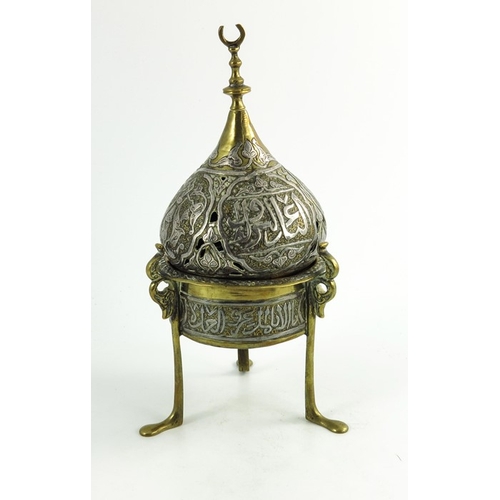 487 - A 19th century or earlier Persian cairoware brass and silver overlay incense burner and cover, the c... 