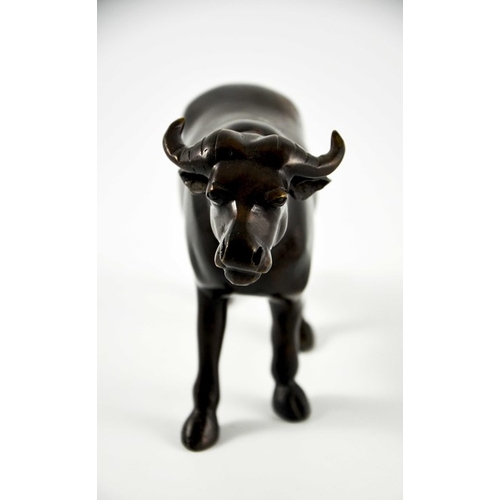 488 - An Oriental bronze figure of a water buffalo, modelled standing, 15cm high, 26cm long