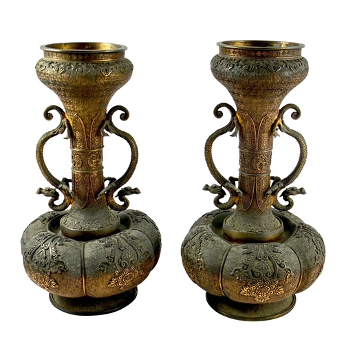 490 - A large pair of Japanese bronze vases, Meiji, melon and shaft form, heavily cast in relief with rose... 