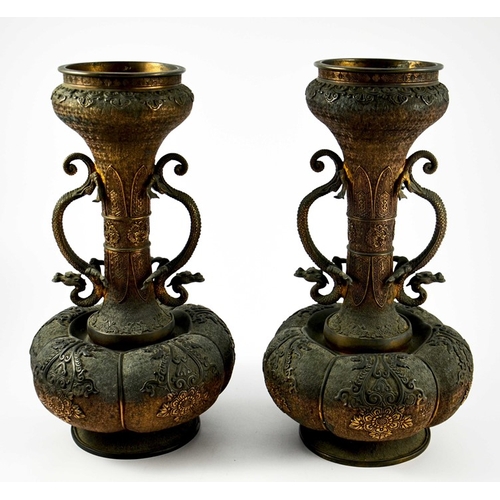 490 - A large pair of Japanese bronze vases, Meiji, melon and shaft form, heavily cast in relief with rose... 