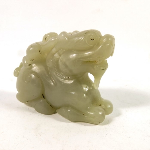 493 - A Chinese jade carving of a boy on the back of a dragon, 8cm