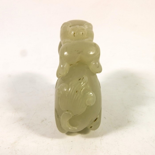 493 - A Chinese jade carving of a boy on the back of a dragon, 8cm