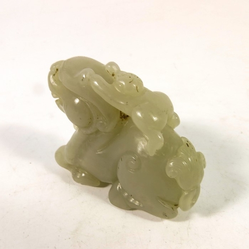 493 - A Chinese jade carving of a boy on the back of a dragon, 8cm