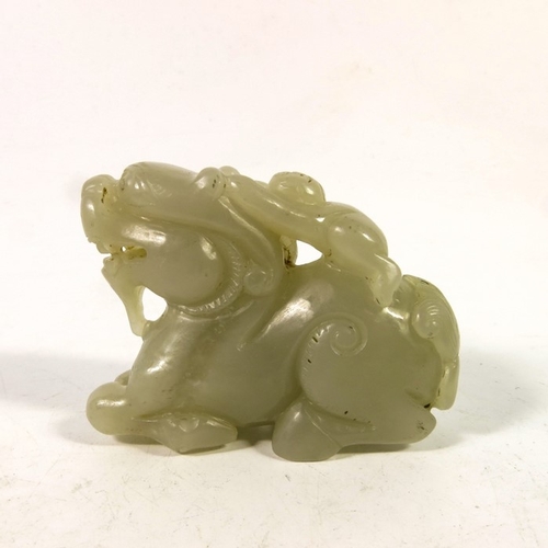 493 - A Chinese jade carving of a boy on the back of a dragon, 8cm