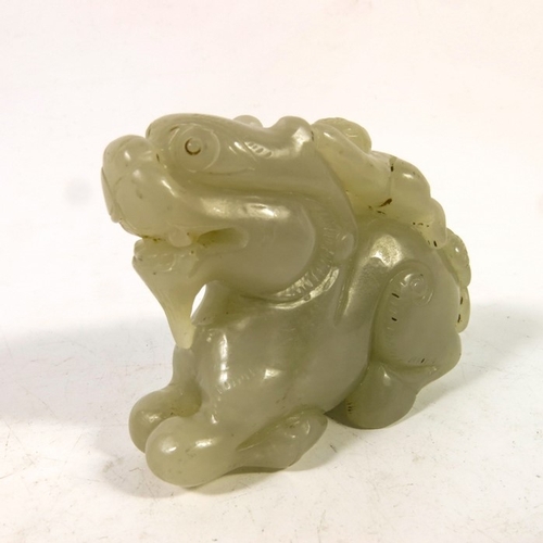 493 - A Chinese jade carving of a boy on the back of a dragon, 8cm