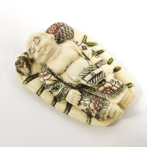 495 - λ A 19th century Japanese ivory netsuke, Meiji, modelled as a sleeping man, 6cm long