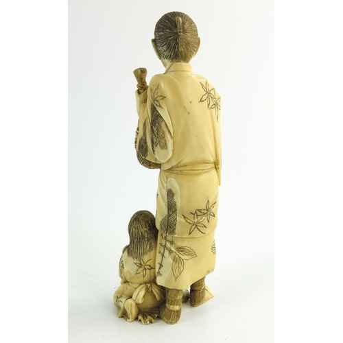 497 - λ A 19th century Japanese ivory okimono, Meiji, modelled as a father and son, 15cm high