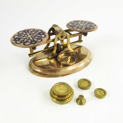 522 - A set of Victorian gilt brass and champlevé enamelled postage scales, each plate with blue knotted f... 