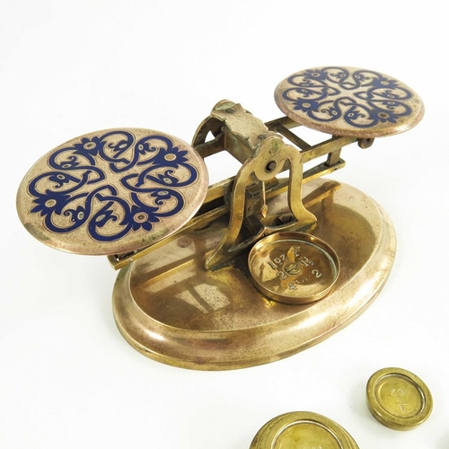 522 - A set of Victorian gilt brass and champlevé enamelled postage scales, each plate with blue knotted f... 