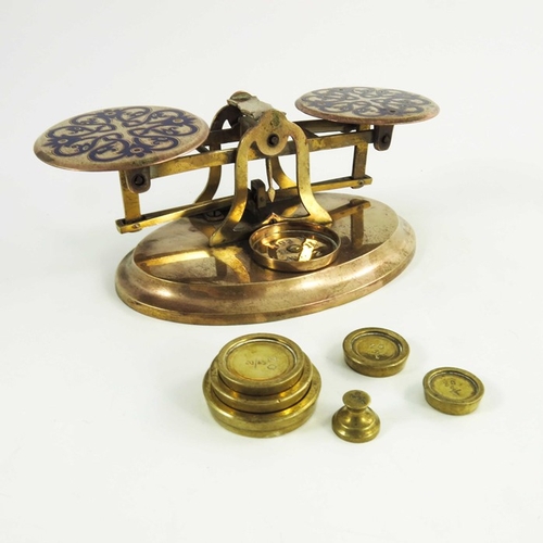 522 - A set of Victorian gilt brass and champlevé enamelled postage scales, each plate with blue knotted f... 