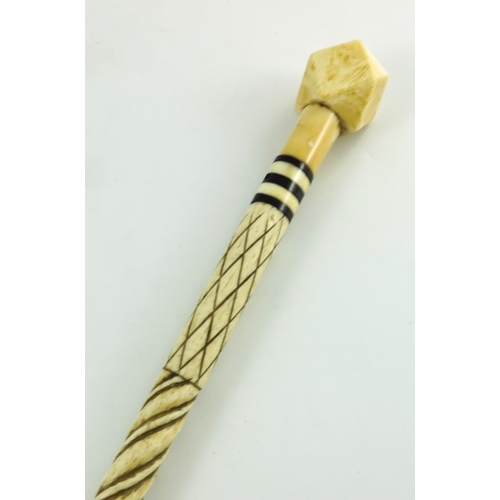 525 - A 19th century marine ivory and whale bone walking stick, the carved spiral whalebone cane shaft wit... 