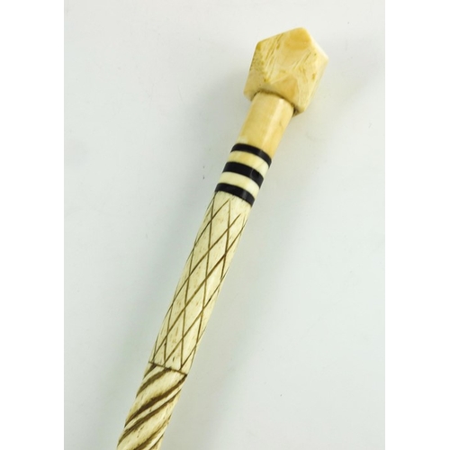 525 - A 19th century marine ivory and whale bone walking stick, the carved spiral whalebone cane shaft wit... 