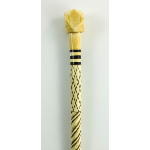 525 - A 19th century marine ivory and whale bone walking stick, the carved spiral whalebone cane shaft wit... 